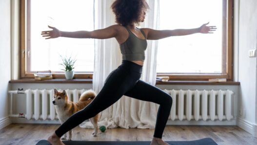 Fit woman working out in living room on yoga mat